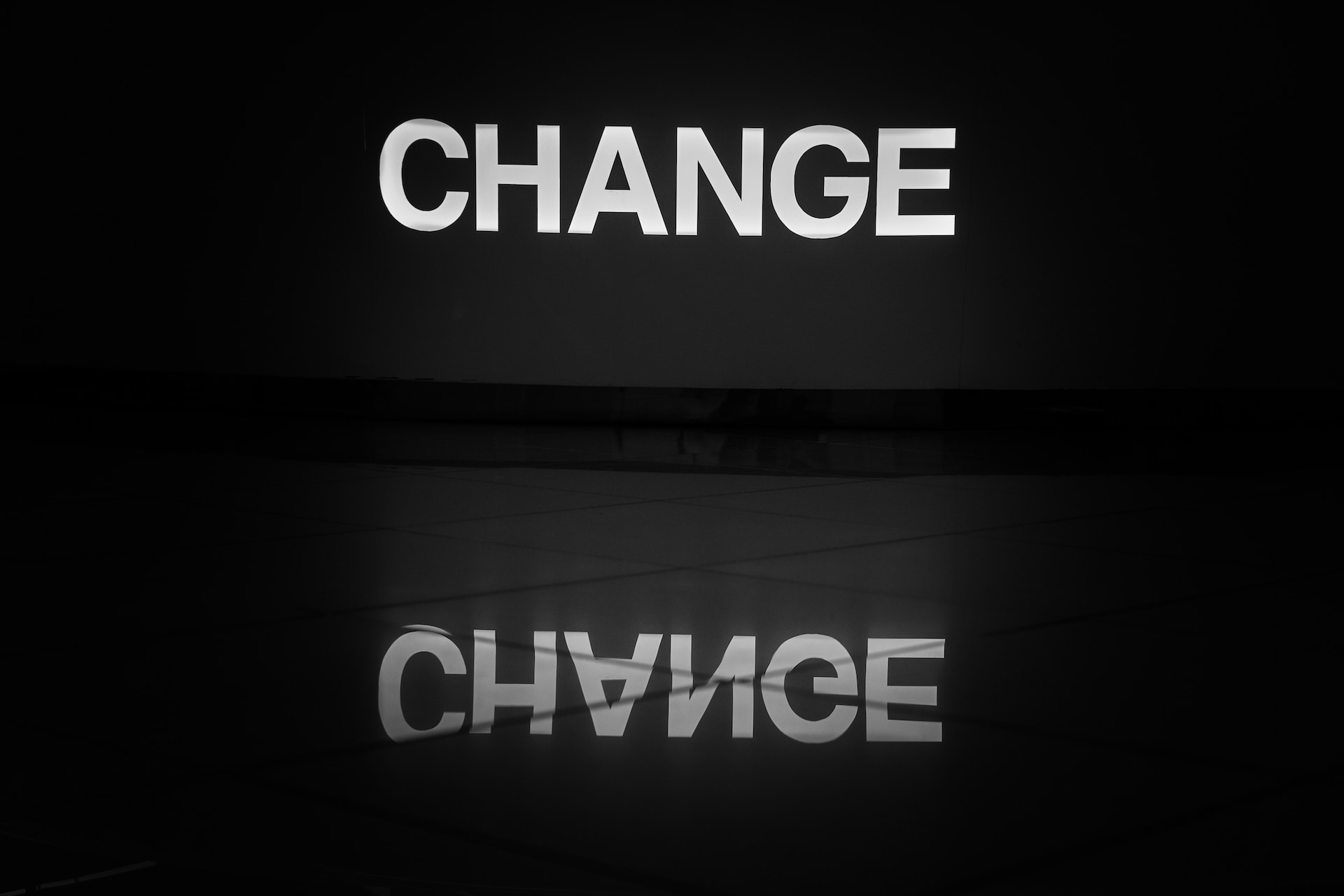 A black and white photo of a sign that says "change"